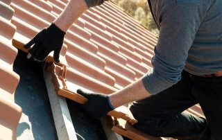 Griffin Roofing in Atlanta, GA - a picture of a roofer installing a clay tile