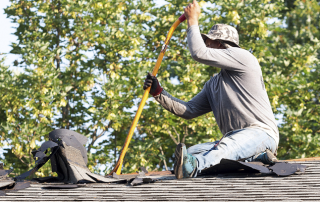Griffin Roofing in Atlanta, GA - A roofer is working on a damaged roof
