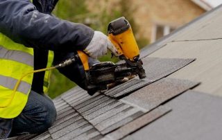Griffin Roofing in Atlanta, GA - A roofer nailing shingles with air gun